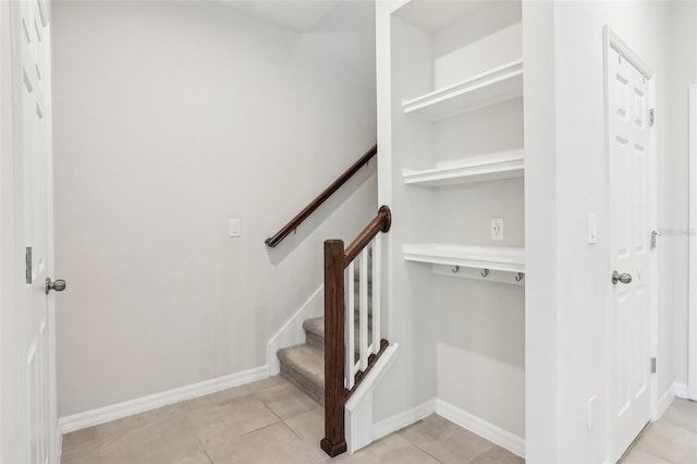 staircase featuring tile patterned flooring