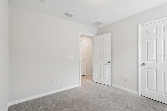 unfurnished bedroom featuring light colored carpet