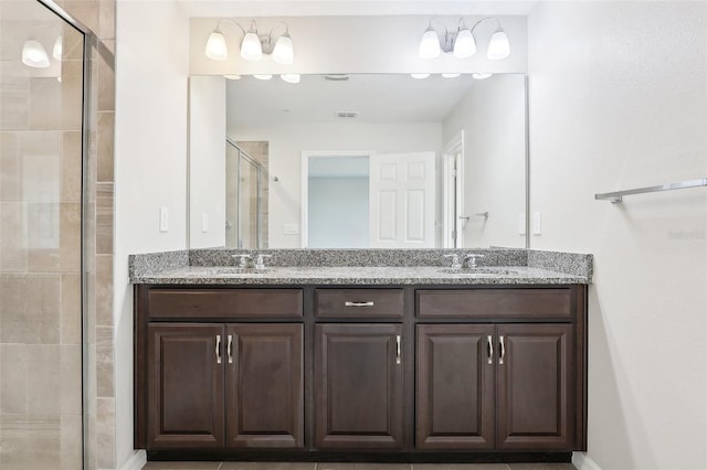 bathroom featuring vanity and an enclosed shower