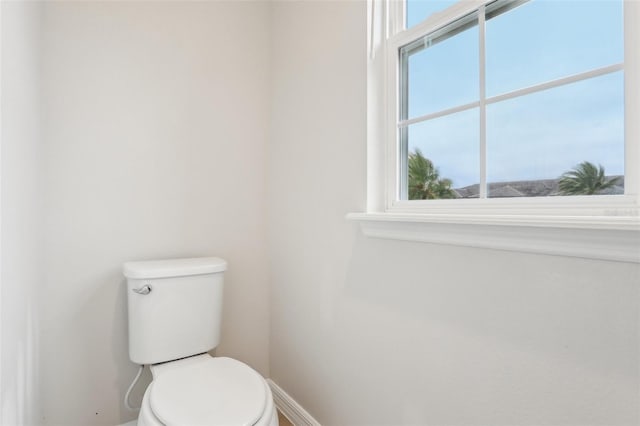 bathroom with a healthy amount of sunlight and toilet