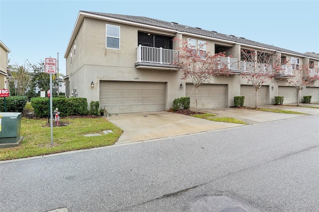 multi unit property with a balcony and a garage