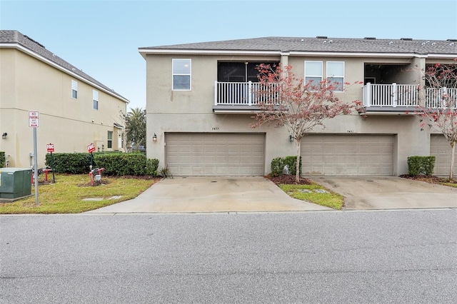 townhome / multi-family property with a balcony and a garage