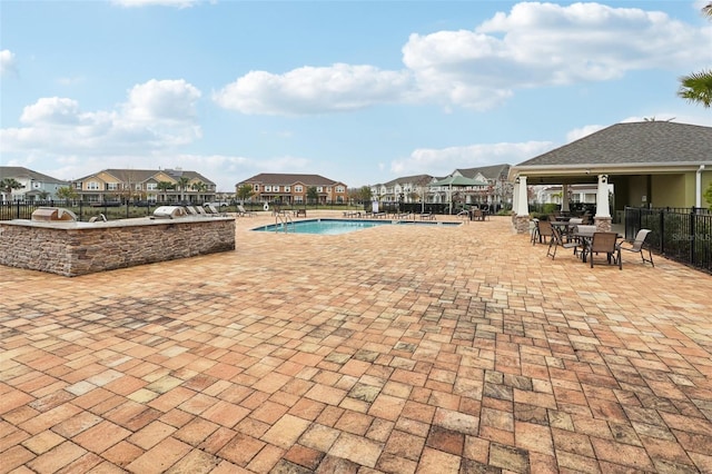 view of pool featuring area for grilling and a patio