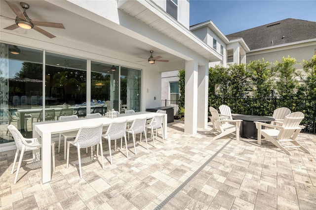 view of patio with ceiling fan and exterior bar