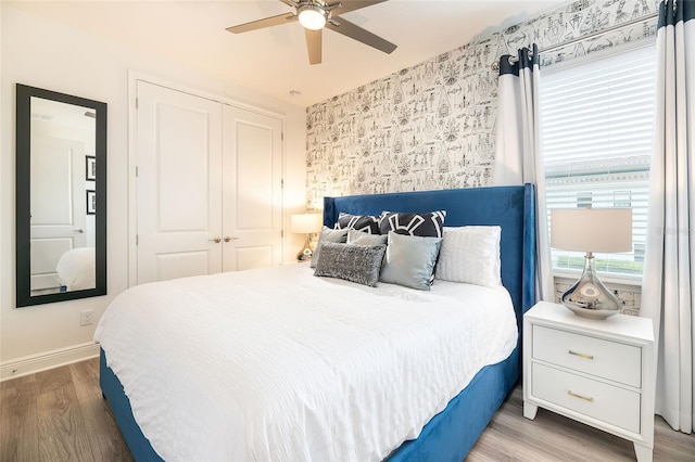 bedroom with a closet, ceiling fan, and hardwood / wood-style floors