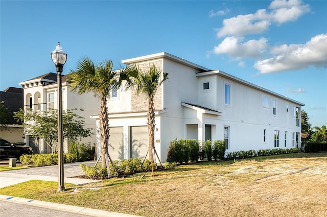 view of property exterior featuring a yard and a garage