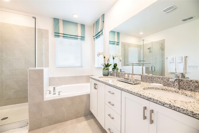 bathroom with tile patterned floors, vanity, and shower with separate bathtub