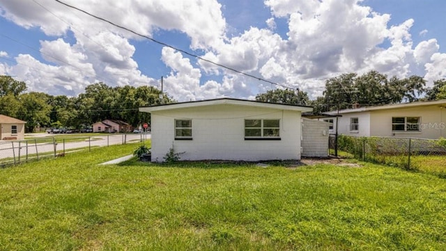 rear view of property featuring a yard