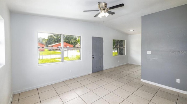 tiled spare room with ceiling fan and lofted ceiling