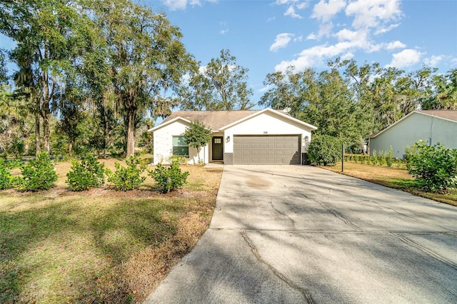 single story home with a garage and a front yard