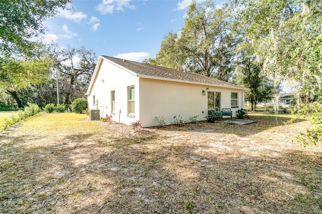 view of property exterior featuring a patio and central AC