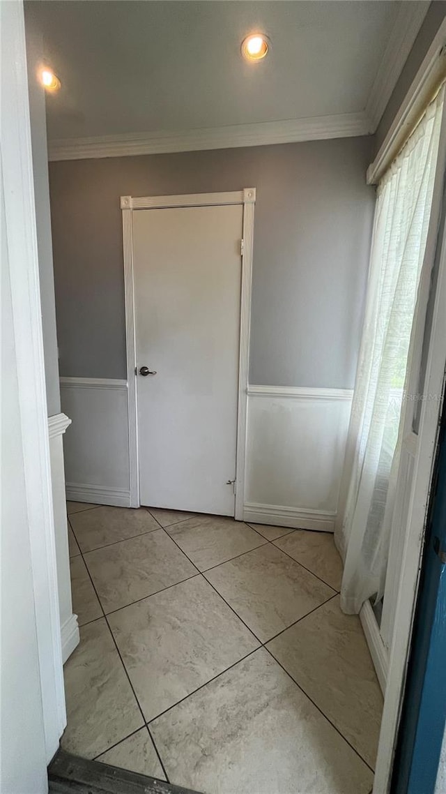 bathroom featuring ornamental molding and tile patterned floors