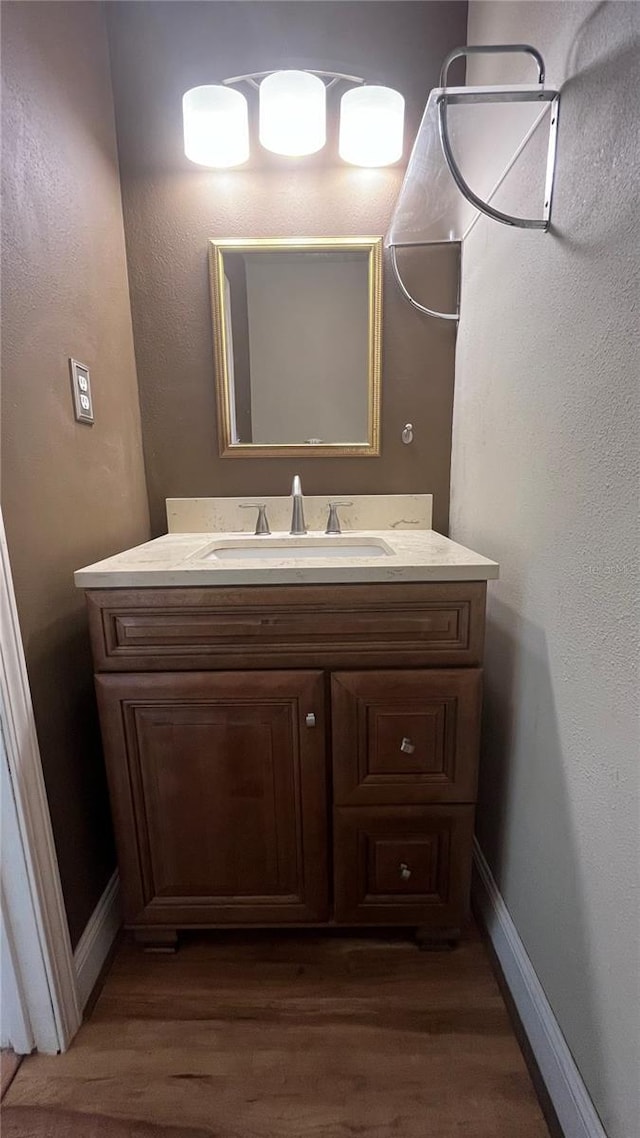 bathroom featuring vanity and hardwood / wood-style floors