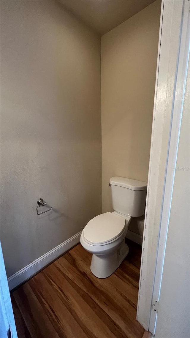 bathroom featuring hardwood / wood-style flooring and toilet