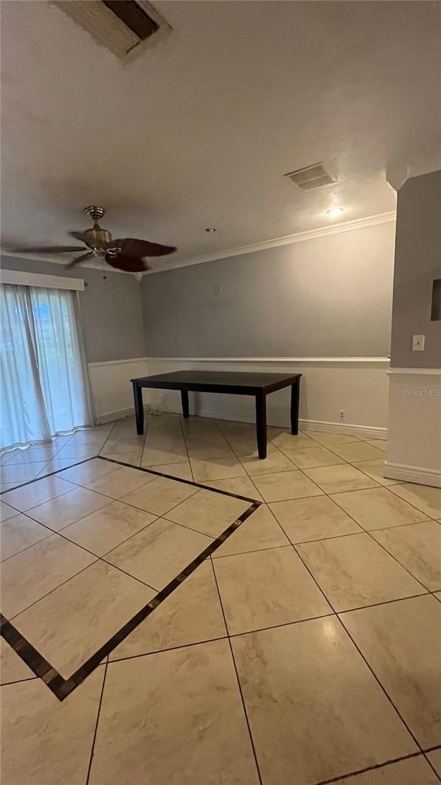 empty room with light tile patterned flooring, ceiling fan, and crown molding