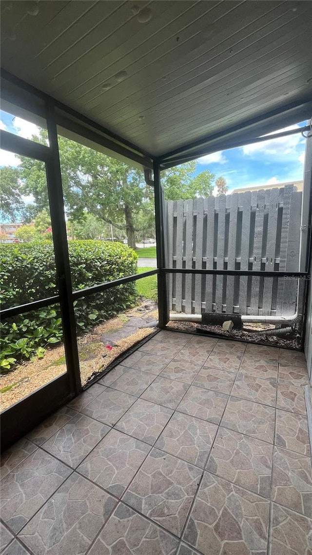 unfurnished sunroom with wooden ceiling