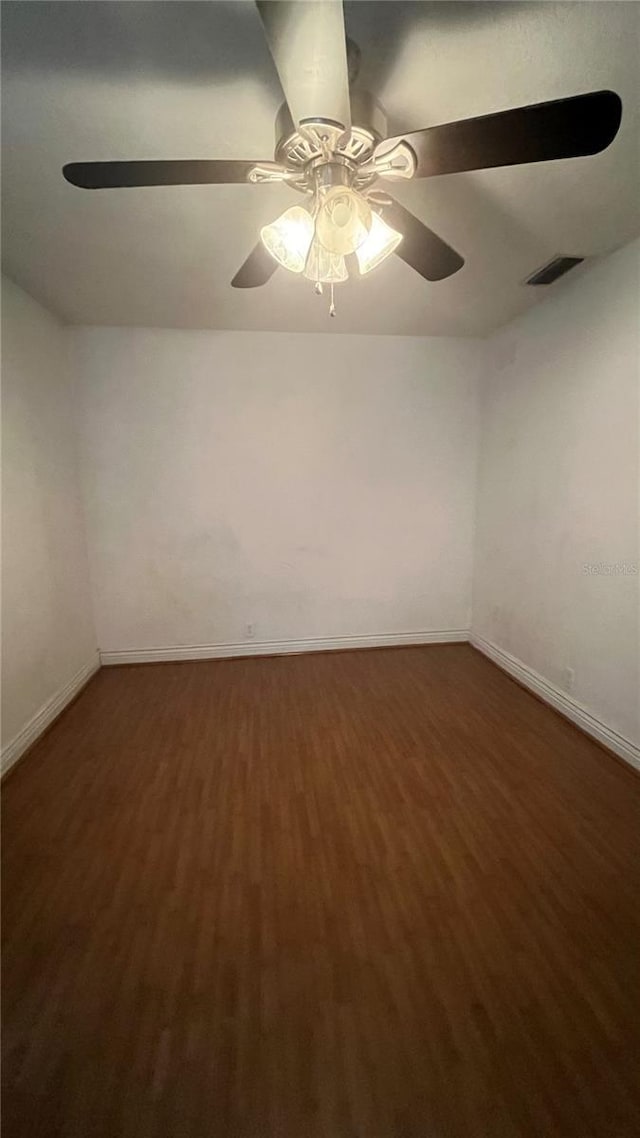 spare room with ceiling fan and dark hardwood / wood-style flooring