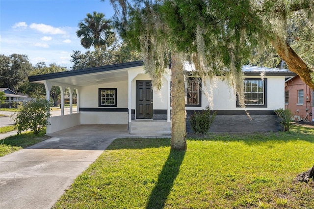 ranch-style home with a front lawn and a carport