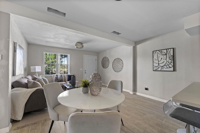 dining space with light hardwood / wood-style flooring