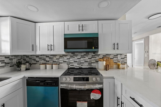 kitchen featuring a textured ceiling, white cabinetry, stainless steel appliances, and tasteful backsplash