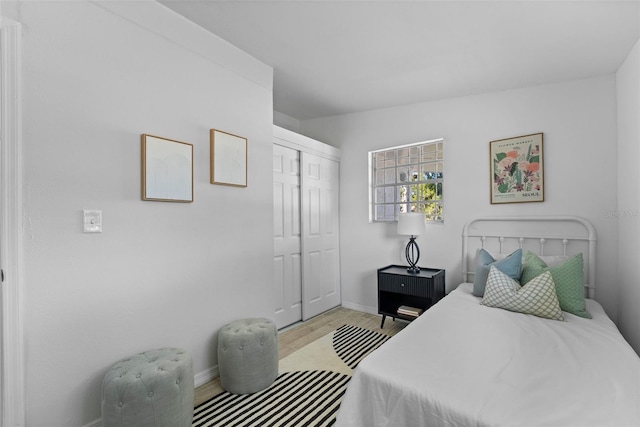 bedroom with a closet and light hardwood / wood-style flooring