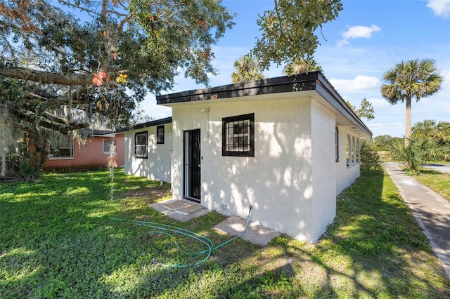 rear view of property featuring a yard