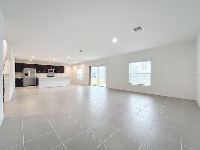 unfurnished living room with light tile patterned flooring