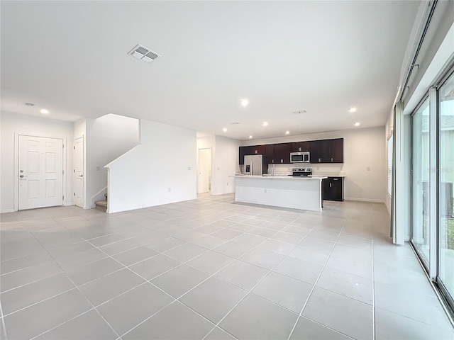 unfurnished living room featuring light tile patterned flooring