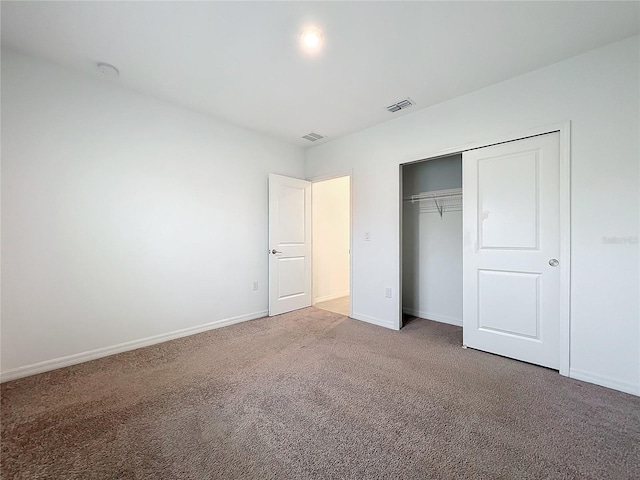 unfurnished bedroom with carpet and a closet