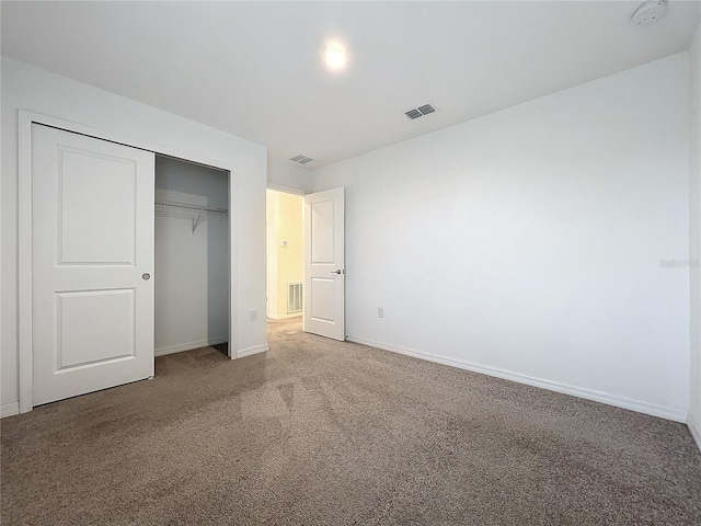 unfurnished bedroom with carpet floors and a closet