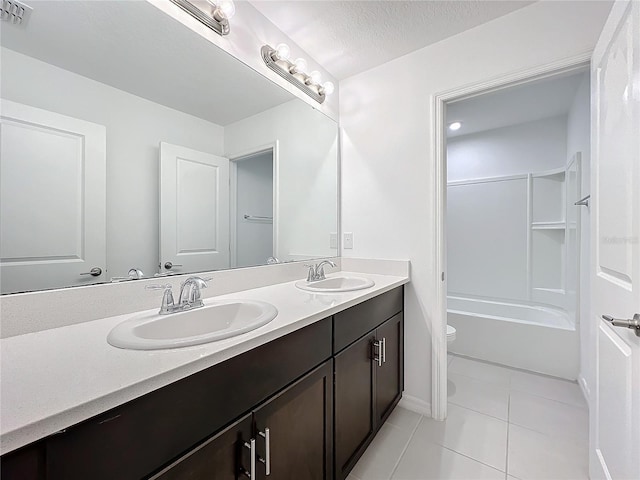 full bathroom featuring tile patterned flooring, bathtub / shower combination, toilet, a textured ceiling, and vanity