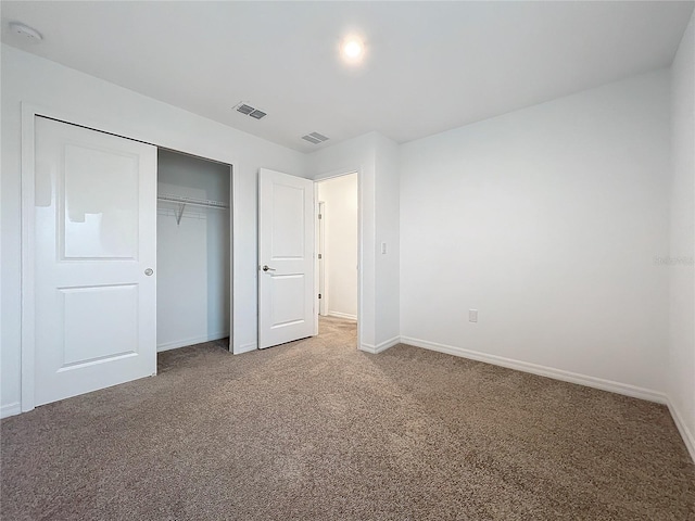 unfurnished bedroom with carpet and a closet