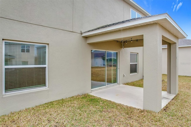 exterior space with a patio area and a lawn