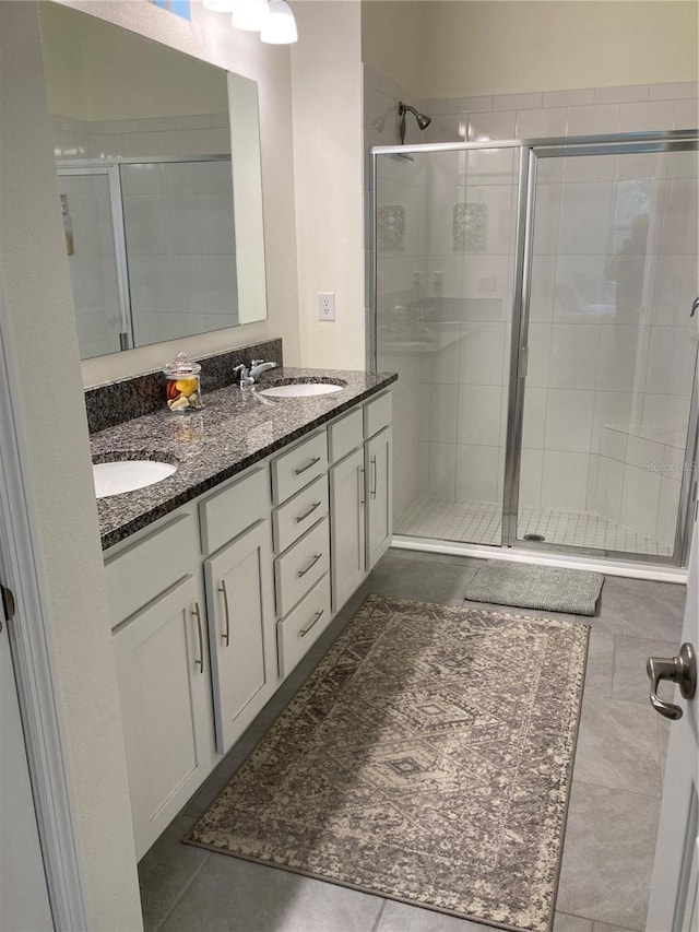 bathroom featuring vanity, tile patterned flooring, and walk in shower