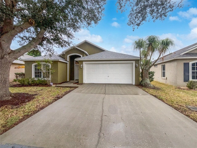 ranch-style house with a garage and a front lawn