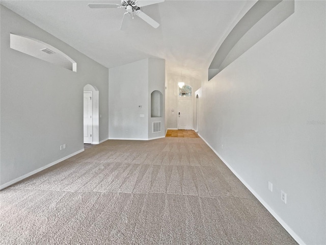 unfurnished living room with ceiling fan and carpet floors