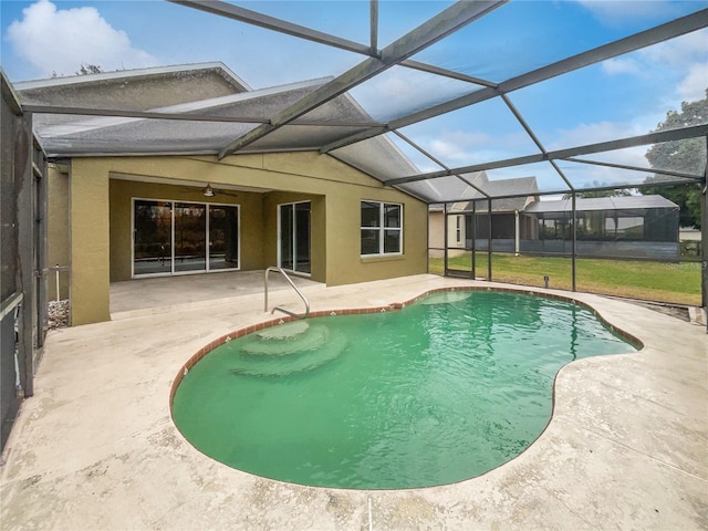 view of pool with ceiling fan, a patio, and a lanai