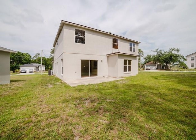 1010 Embrun Ct, Kissimmee, FL 34759 - back of property with a yard, a patio, central AC, and stucco siding