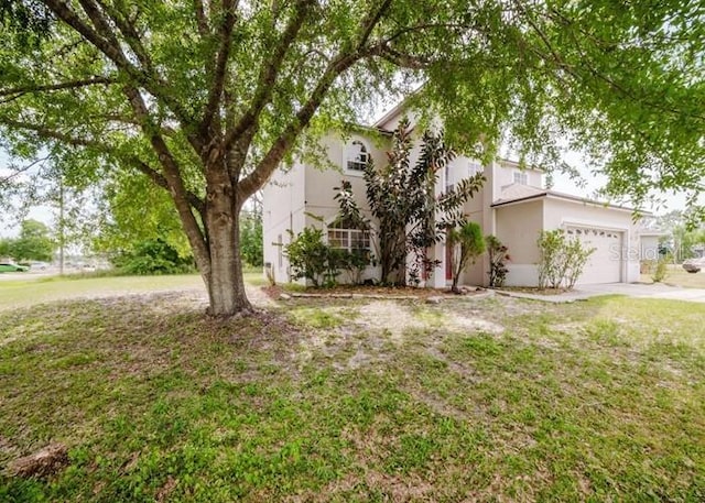 1010 Embrun Ct, Kissimmee, FL 34759 - obstructed view of property with a garage, stucco siding, driveway, and a front yard