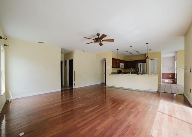 1010 Embrun Ct, Kissimmee, FL 34759 - unfurnished living room with baseboards, a ceiling fan, light wood-style flooring, and visible vents