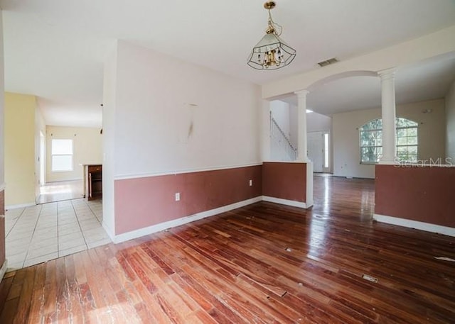 1010 Embrun Ct, Kissimmee, FL 34759 - spare room with baseboards, wood-type flooring, ornate columns, and visible vents