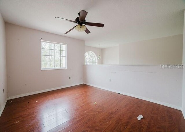1010 Embrun Ct, Kissimmee, FL 34759 - unfurnished room with baseboards, a ceiling fan, and wood finished floors