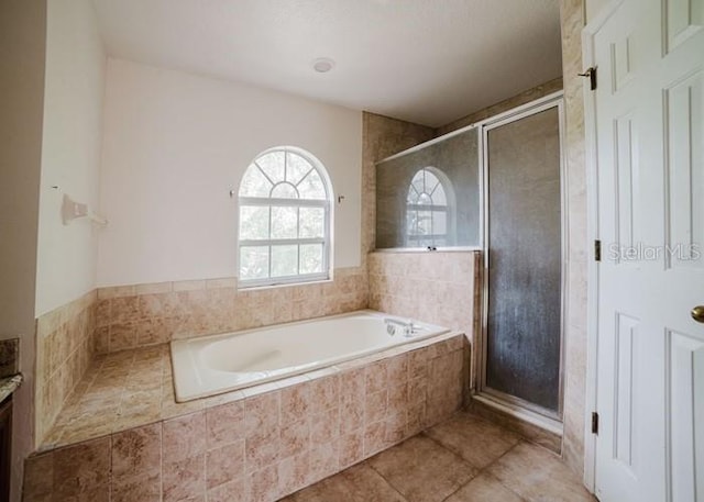 1010 Embrun Ct, Kissimmee, FL 34759 - bathroom featuring vanity, tile patterned floors, a bath, and a stall shower