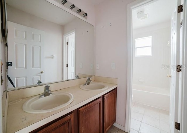 1010 Embrun Ct, Kissimmee, FL 34759 - full bathroom featuring double vanity, a sink, and tile patterned floors