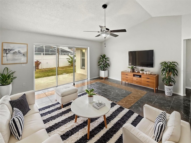 living room featuring ceiling fan, a textured ceiling, and vaulted ceiling