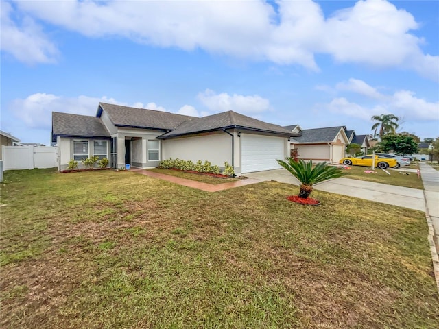 ranch-style house featuring a garage and a front lawn