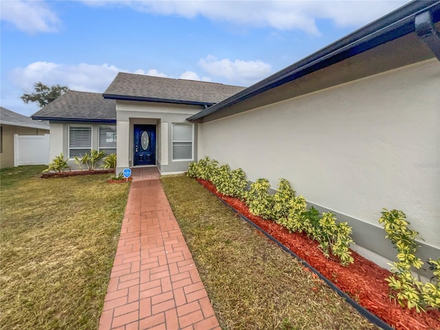 property entrance featuring a lawn