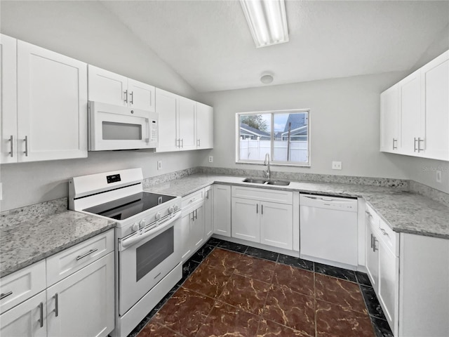 kitchen with sink, white appliances, white cabinets, and lofted ceiling