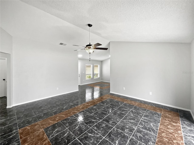 empty room with ceiling fan, a textured ceiling, and lofted ceiling