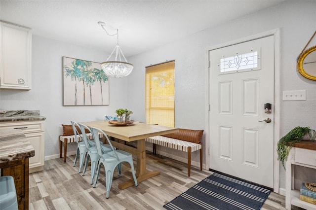 dining room featuring light hardwood / wood-style floors and a chandelier